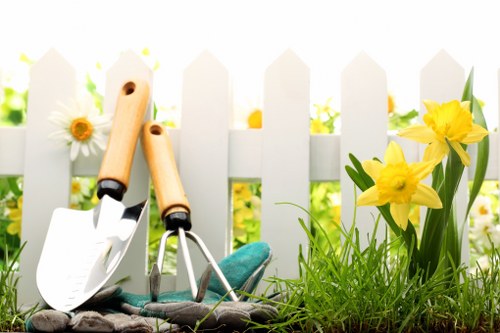 Professional gardeners managing seasonal growth in a Grange Park garden